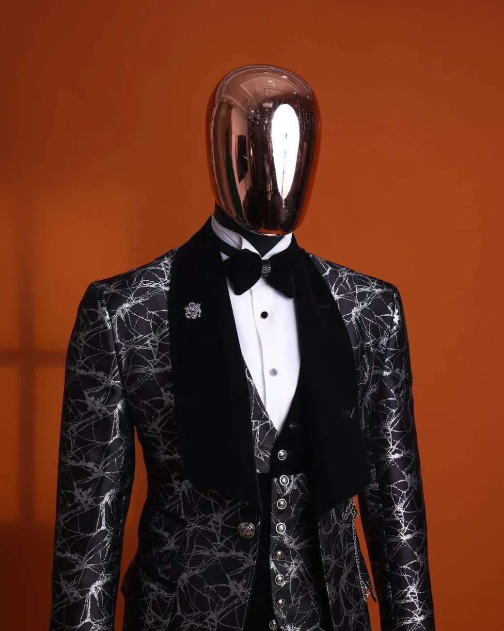 A charcoal black and silver spiral jacquard, shawl lapel tuxedo suit