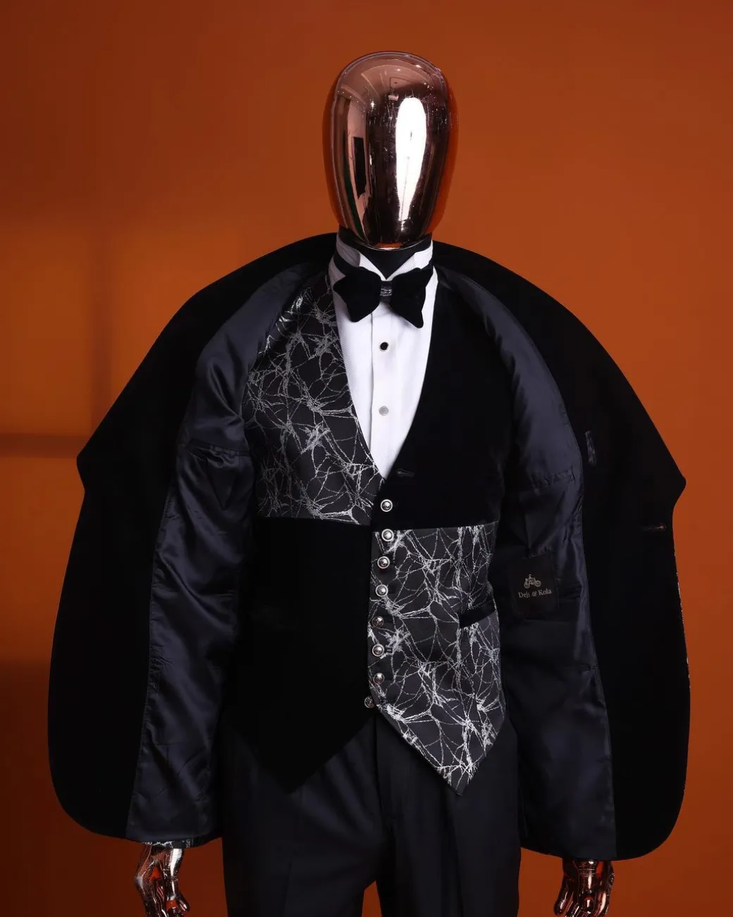 A charcoal black and silver spiral jacquard, shawl lapel tuxedo suit