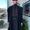 A charcoal black, connected square embroidery design with matching gold and red Swarovski stone details agbada