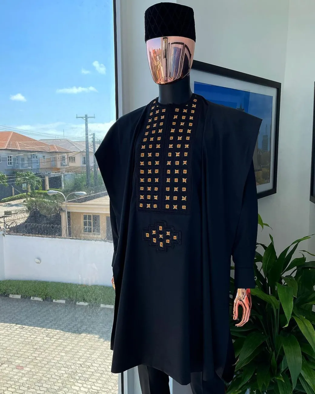 A charcoal black, connected square embroidery design with matching gold and red Swarovski stone details agbada
