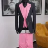 A charcoal black “contrast” pink notch lapel suit