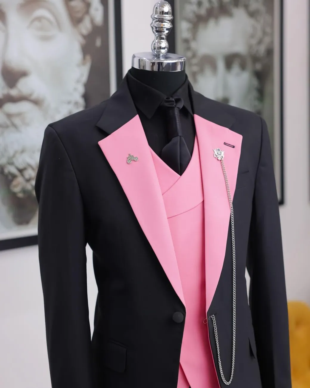 A charcoal black “contrast” pink notch lapel suit
