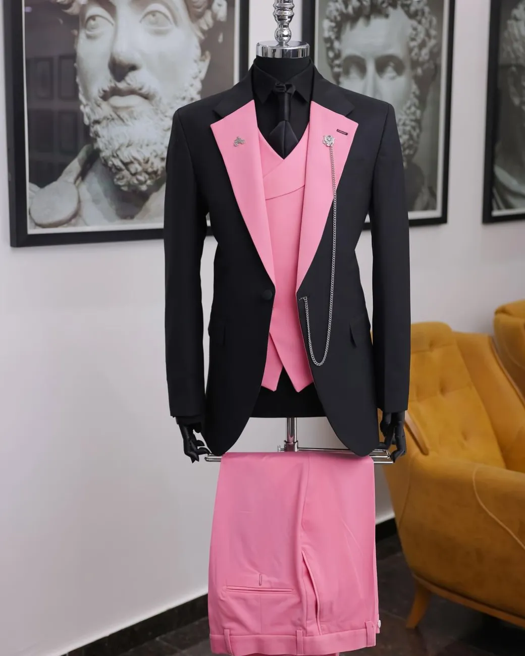 A charcoal black “contrast” pink notch lapel suit