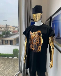 A charcoal black “daftan” with a tiger prints & black Fulani hat