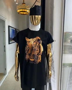 A charcoal black “daftan” with a tiger prints & black Fulani hat