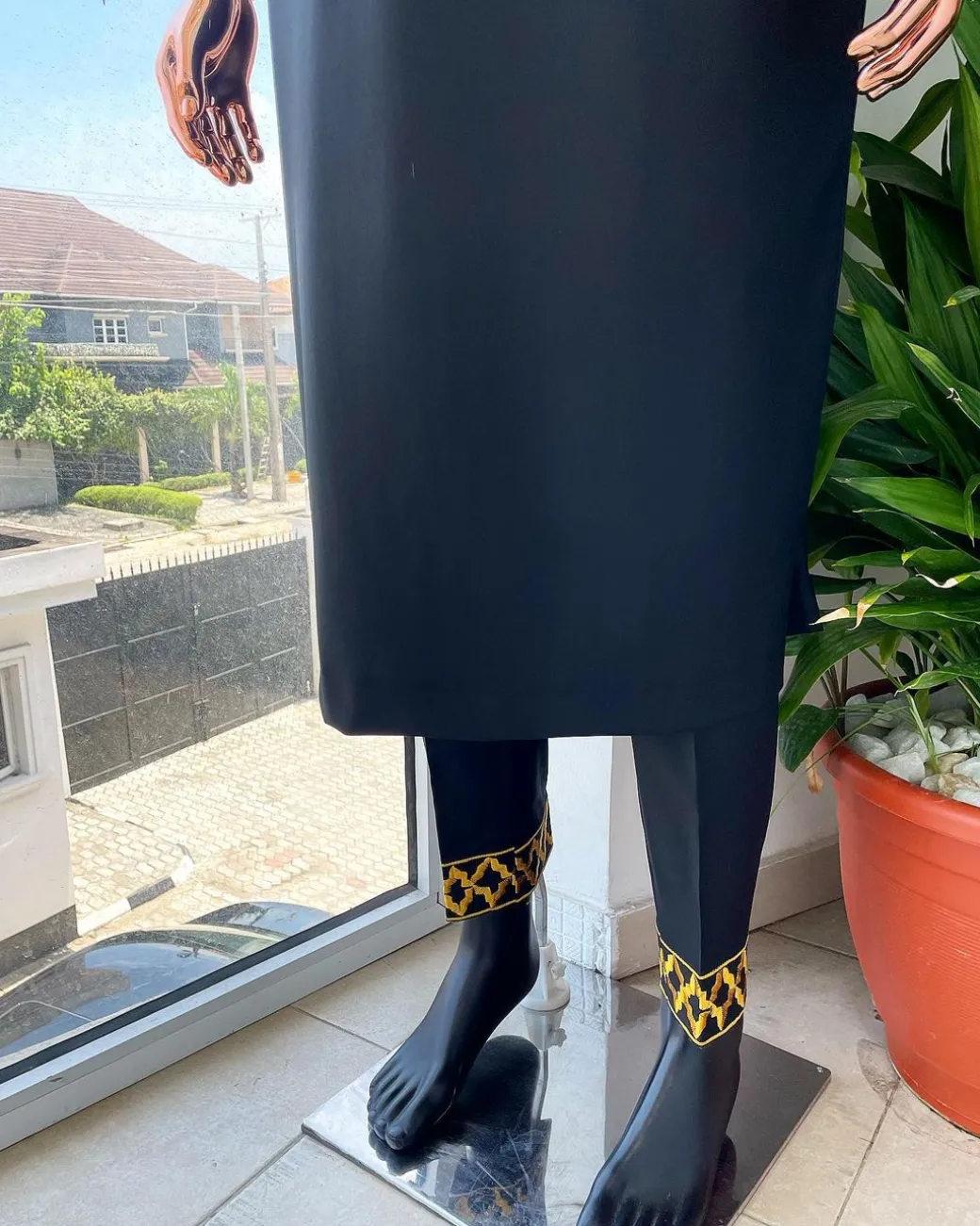 A charcoal black dagbtan, connected star gold embroidery detailing senator native.