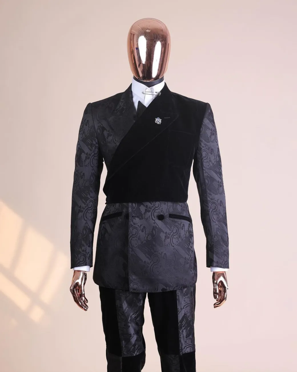 A charcoal black “equalizer” quadruple breasted, knitted, peak lapel with velvet tuxedo jacquard suit