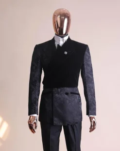 A charcoal black “equalizer” quadruple breasted, knitted, layered peak lapel with velvet overlay-ed tuxedo jacquard suit