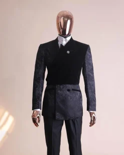 A charcoal black “equalizer” quadruple breasted, knitted, layered peak lapel with velvet overlay-ed tuxedo jacquard suit