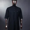 A charcoal black front flap with gold Swarovski buttons, patch pocket, and 3/4 sleeve details African senator kaftan native