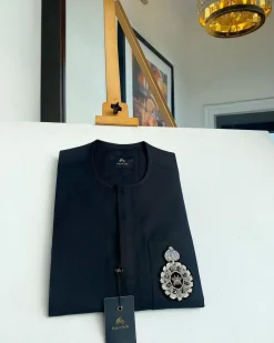 A charcoal black front flap and hand embroidery patch detail traditional African kaftan