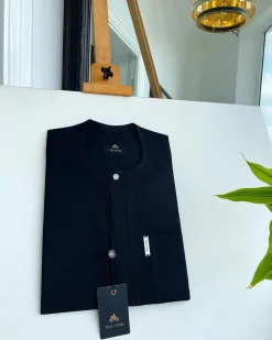 A Charcoal black front flap, interconnected embroidery, and a Swarovski button detail African traditional senator Kaftan native.