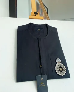 A charcoal black front flap and hand embroidery patch detail traditional African kaftan