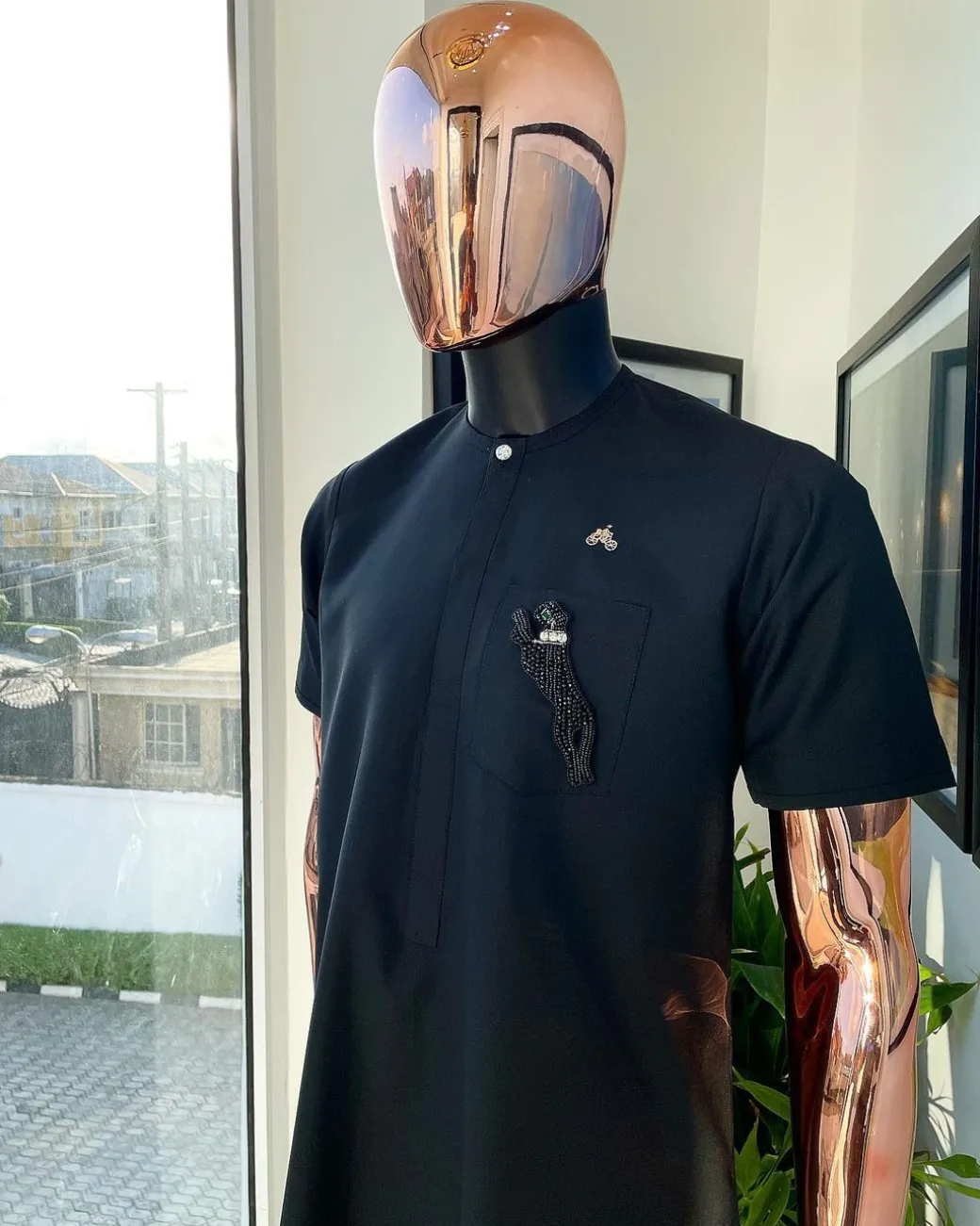 A Charcoal black, front flap, roaring tiger patch design and Swarovski button details african traditional senator kaftan native.