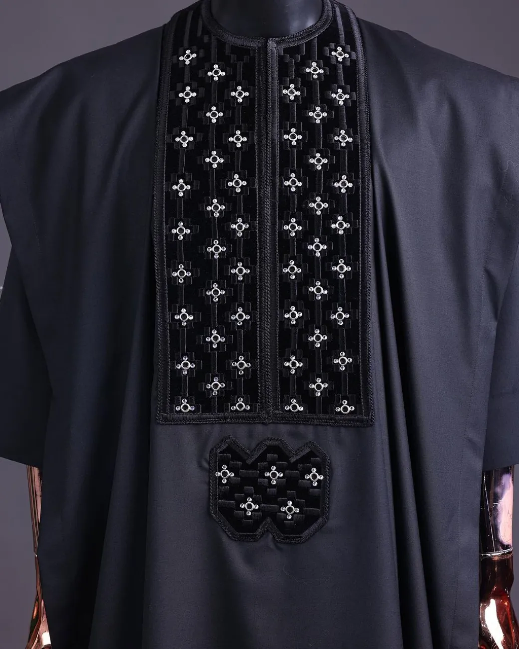 A charcoal black, grommet eyelet on dropping octa with silver Swarovski embroidery details agbada
