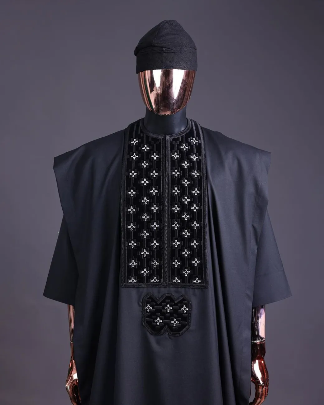 A charcoal black, grommet eyelet on dropping octa with silver Swarovski embroidery details agbada