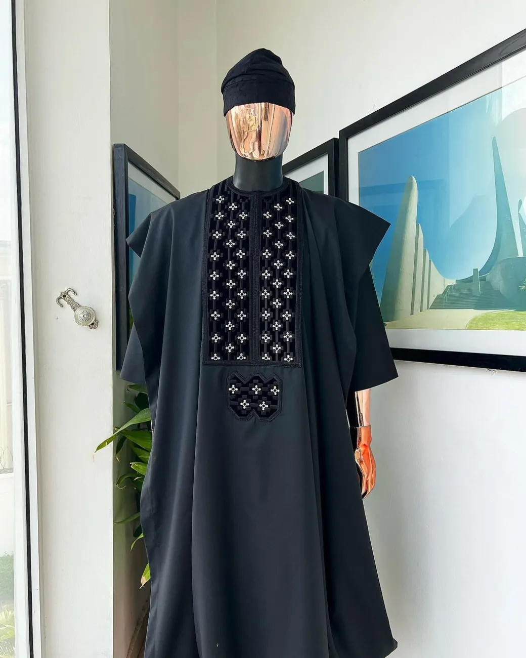 A charcoal black, grommet eyelet on dropping octa with silver Swarovski embroidery details agbada