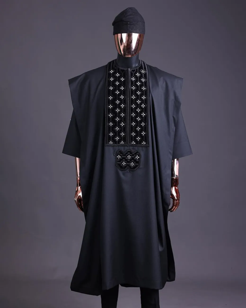 A charcoal black, grommet eyelet on dropping octa with silver Swarovski embroidery details agbada