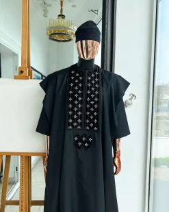 A charcoal black, grommet eyelet on dropping octa with silver Swarovski embroidery details agbada