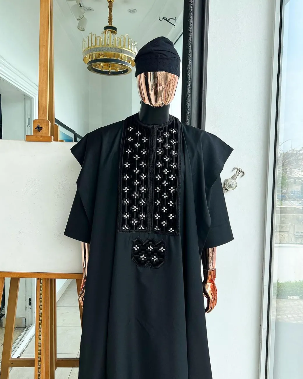 A charcoal black, grommet eyelet on dropping octa with silver Swarovski embroidery details agbada
