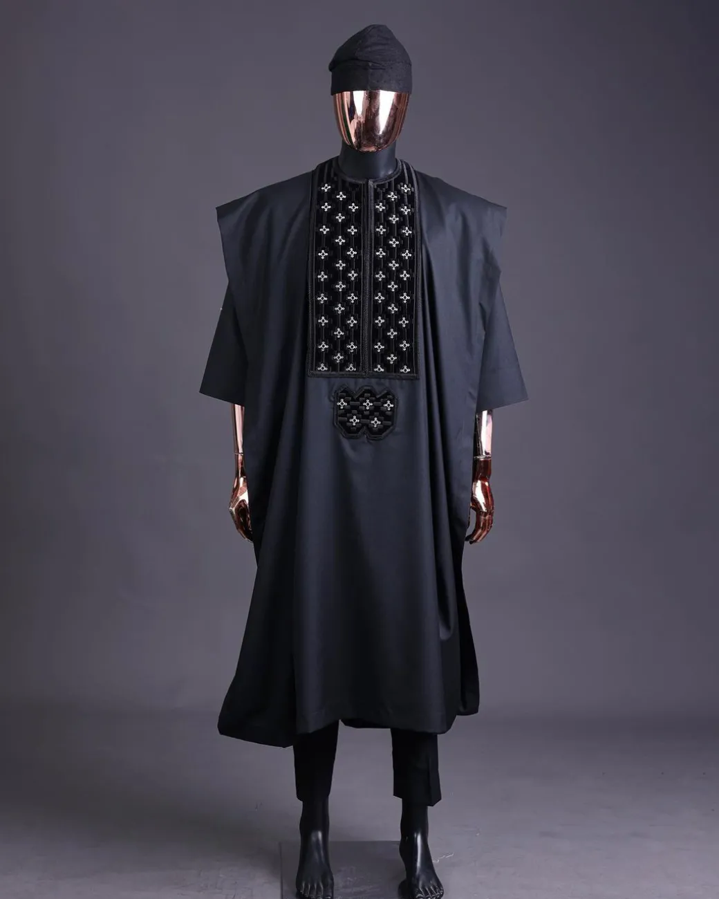 A charcoal black, grommet eyelet on dropping octa with silver Swarovski embroidery details agbada