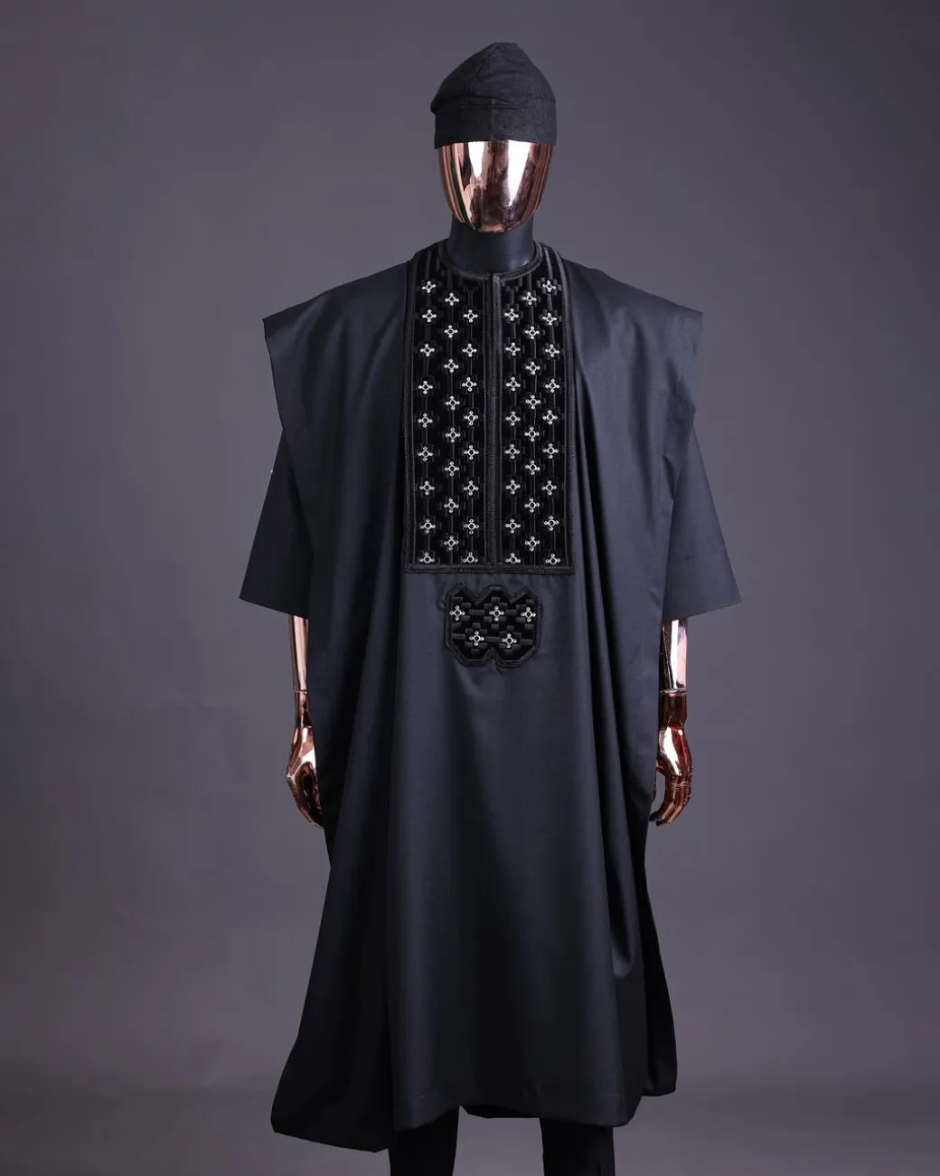 A charcoal black, grommet eyelet on dropping octa with silver Swarovski embroidery details agbada