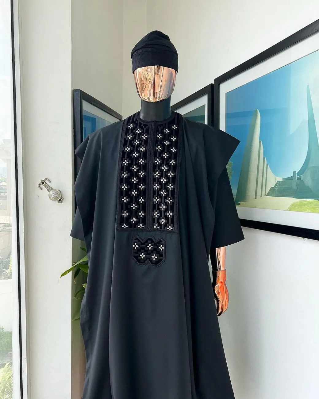 A charcoal black, grommet eyelet on dropping octa with silver Swarovski embroidery details agbada
