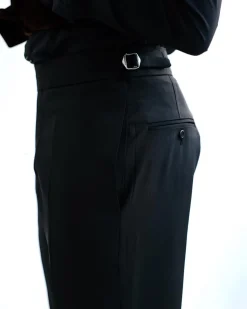A Charcoal Black High Waist, Trumpet-Cut Details Pant With A Side Metal Adjuster.