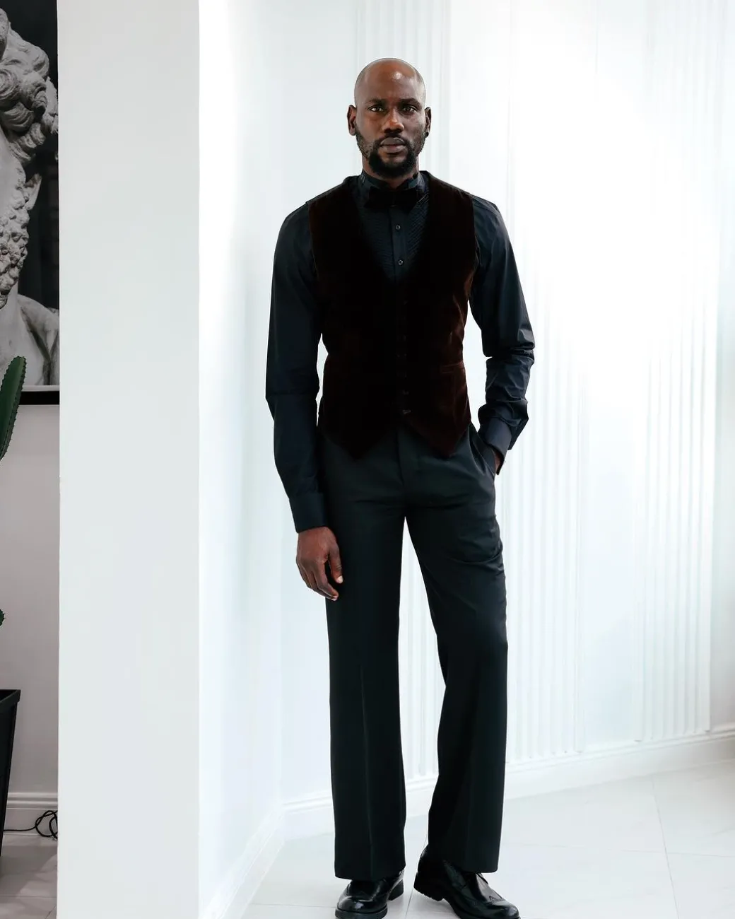 A Charcoal Black High Waist, Trumpet-Cut Details Pant With A Side Metal Adjuster.