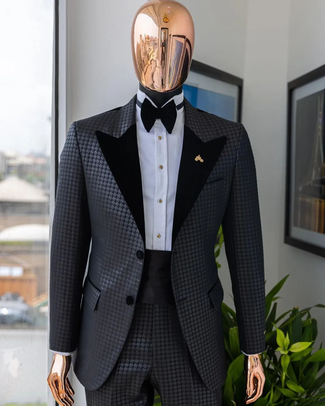 A Charcoal black inverted square patterned metallic jacquard tuxedo with charcoal black velvet peak lapel suit