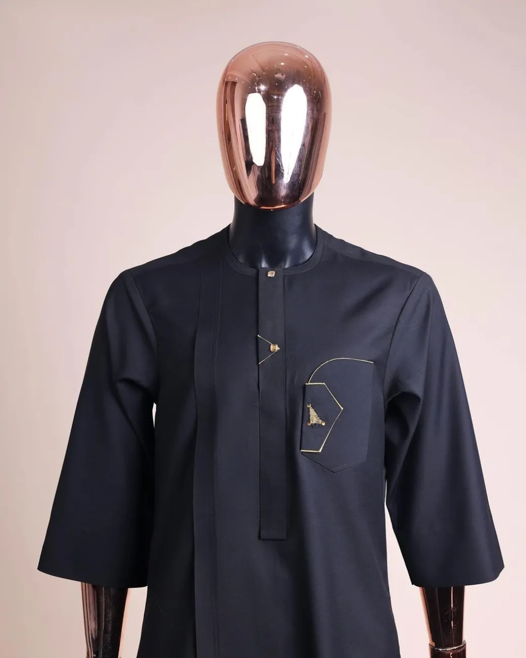 A charcoal black, inverted and closed flap shaped pocket details, 3/4 sleeve African senator kaftan native.