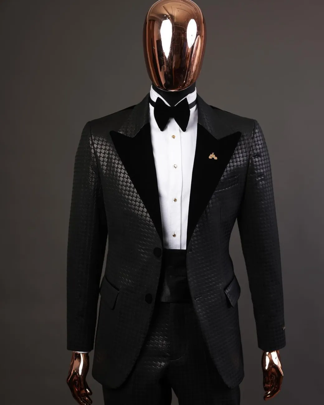 A Charcoal black inverted square patterned metallic jacquard tuxedo with charcoal black velvet peak lapel suit