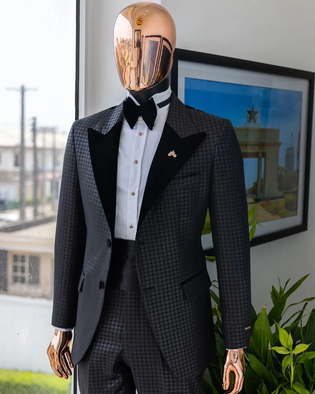A Charcoal black inverted square patterned metallic jacquard tuxedo with charcoal black velvet peak lapel suit