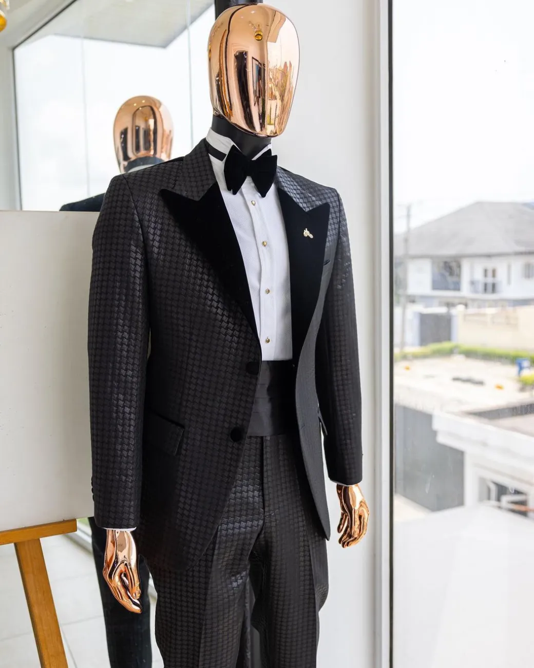 A Charcoal black inverted square patterned metallic jacquard tuxedo with charcoal black velvet peak lapel suit