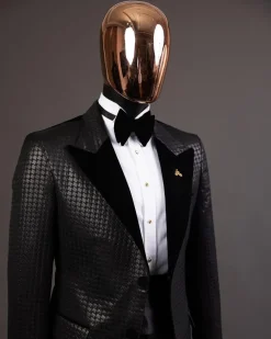 A Charcoal black inverted square patterned metallic jacquard tuxedo with charcoal black velvet peak lapel suit