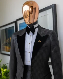 A Charcoal black inverted square patterned metallic jacquard tuxedo with charcoal black velvet peak lapel suit