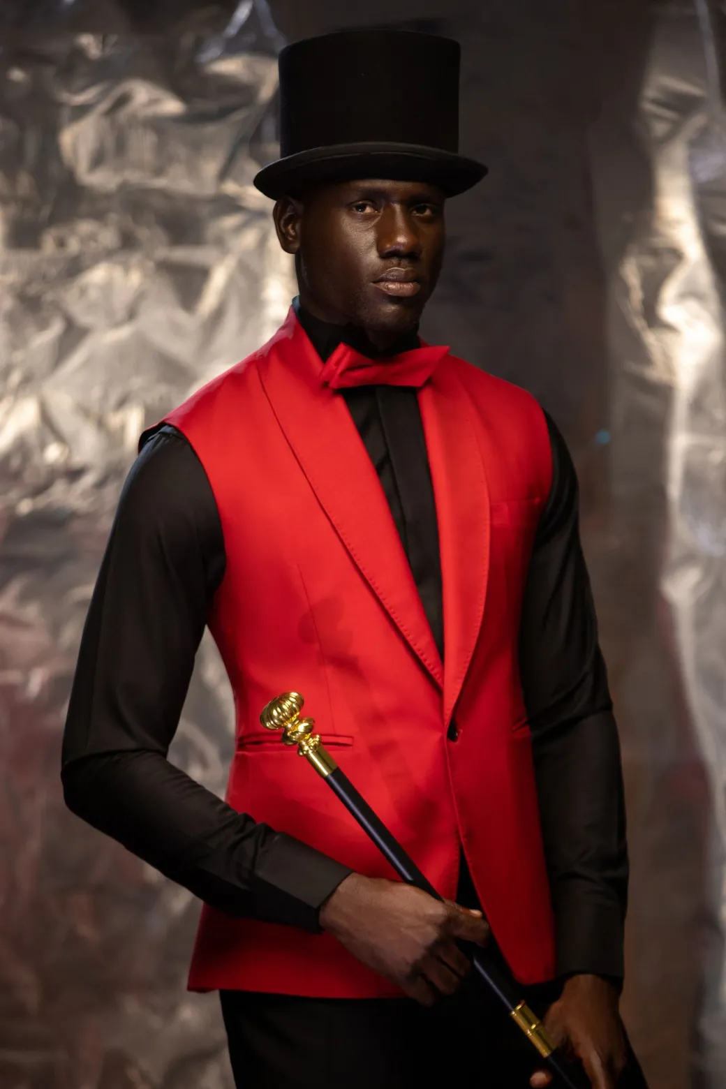 A Charcoal Black Tail Tuxedo Peal Lapel Tuxedo Suit and red Armless One Button Jacket