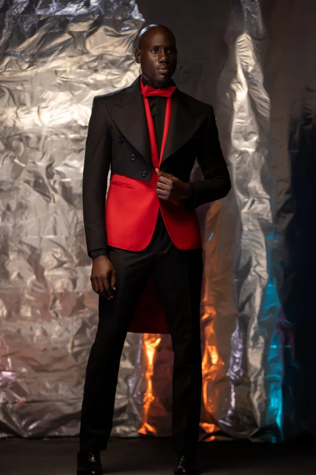 A Charcoal Black Tail Tuxedo Peal Lapel Tuxedo Suit and red Armless One Button Jacket