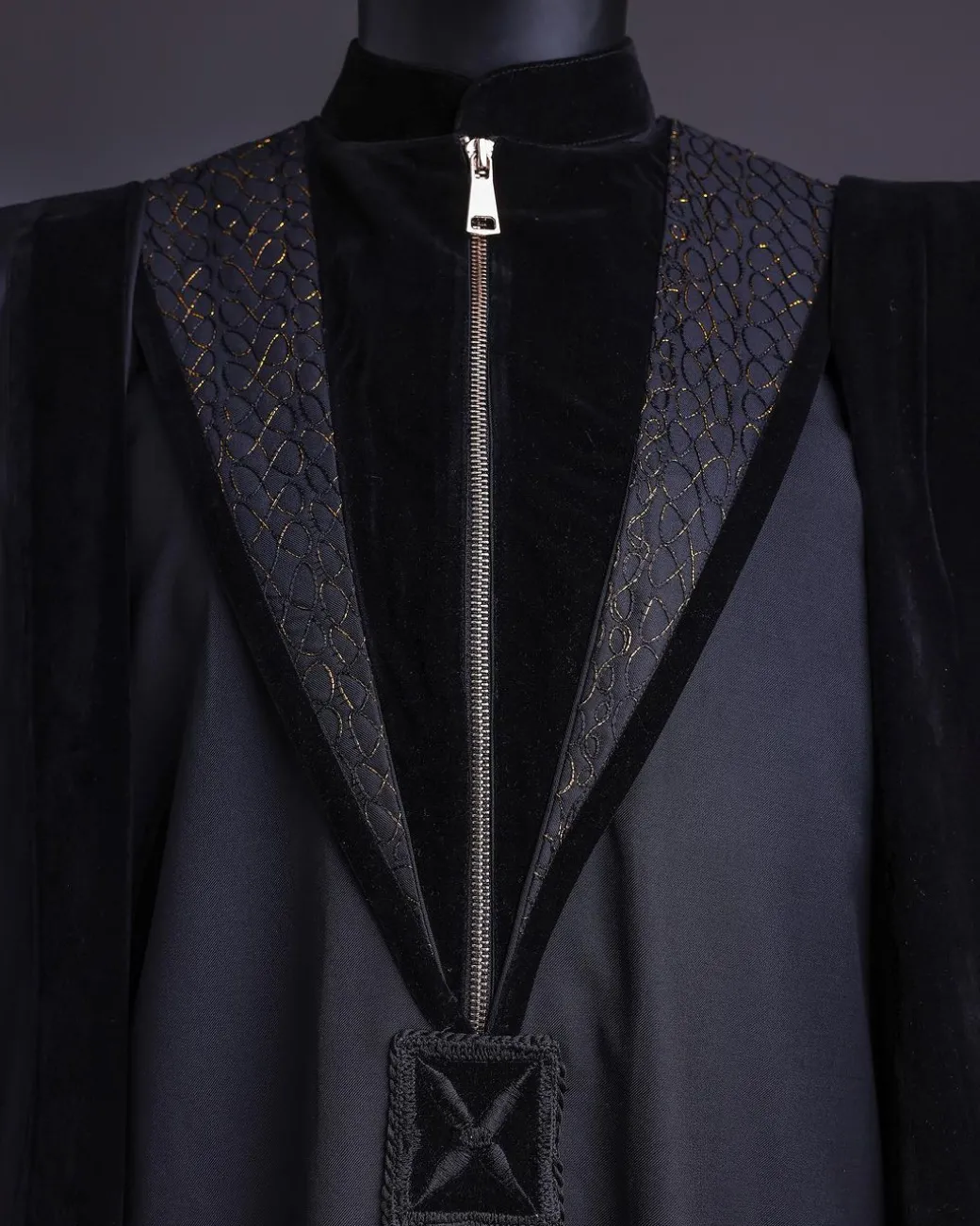A Charcoal Black, Vehicular Lapelled with Zip Line Flap & Velvet Mix Embroidery Design Details Agbada.