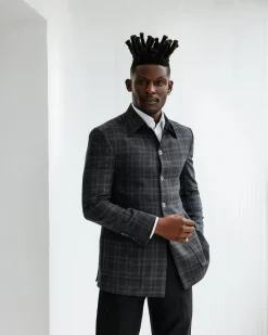 A Charcoal grey, windowpane check, nobility fabric cover coat with patch pocket detailing
