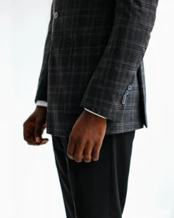 A Charcoal grey, windowpane check, nobility fabric cover coat with patch pocket detailing