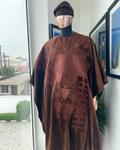 A chocolate brown royal embroidery design agbada, dashiki, hand-knitted matching hat, and Sokoto