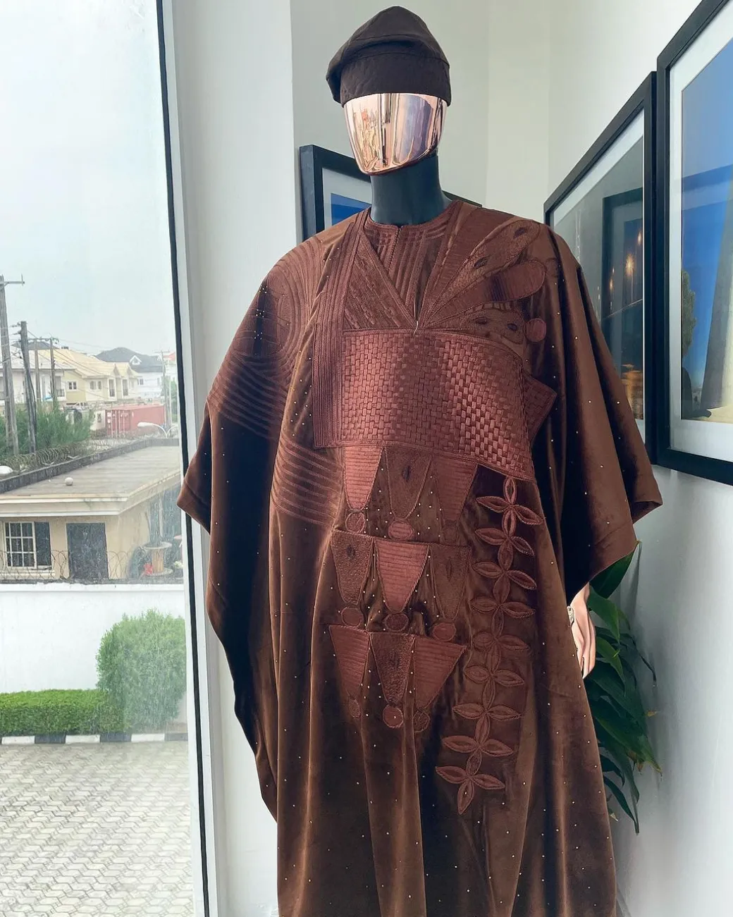 A chocolate brown royal embroidery design agbada, dashiki, hand-knitted matching hat, and Sokoto