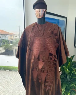 A chocolate brown royal embroidery design agbada, dashiki, hand-knitted matching hat, and Sokoto