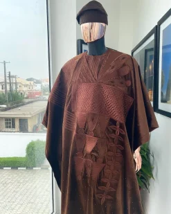 A chocolate brown royal embroidery design agbada, dashiki, hand-knitted matching hat, and Sokoto