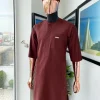 A cinnamon brown 3/4 sleeve kaftan, Swarovski buttons, flap, and spiral binding embroidery hat detailing traditional senator kaftan native