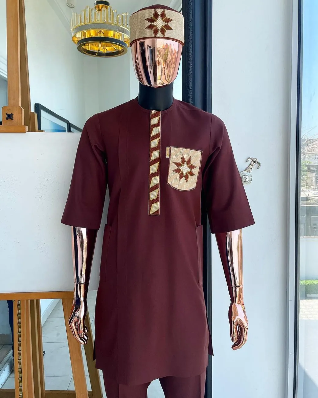 A cinnamon brown, sunrise in the east embroidery detailing hat & patch pocket traditional senator kaftan native.