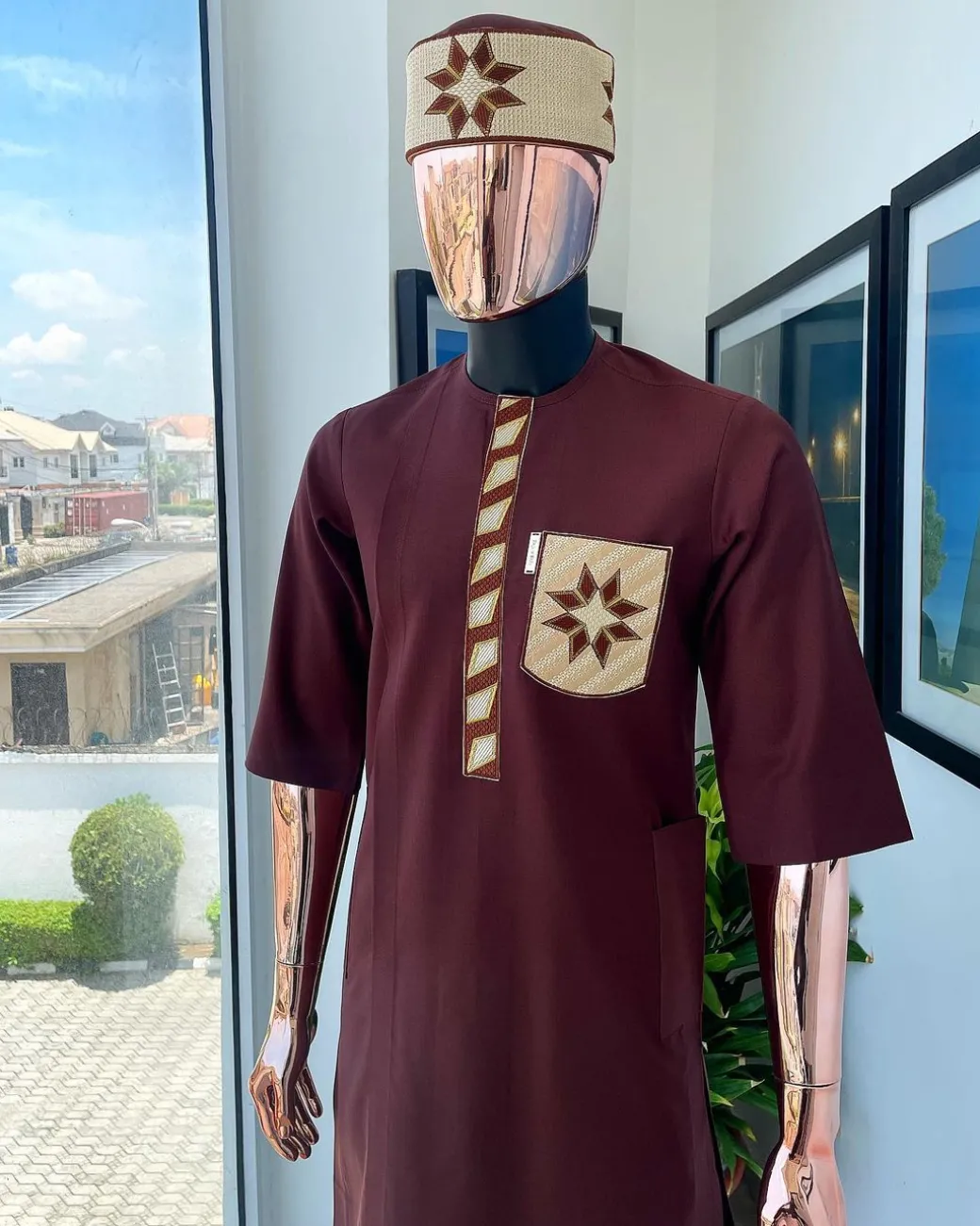 A cinnamon brown, sunrise in the east embroidery detailing hat & patch pocket traditional senator kaftan native.