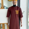 A Cinnamon brown, sunset in the east embroidery detailing hat and patch pocket traditional senator kaftan native.