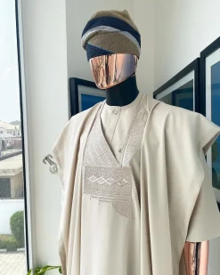 A coconut ivory, jakan design agbada, 3/4 sleeve buba laced with Swarovski stone button details and sokoto